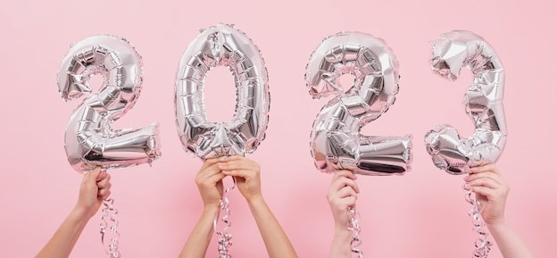happy-new-year-2023-celebration-silver-foil-balloons-numeral-2023-on-a-pink-background_169016-14452.jpg